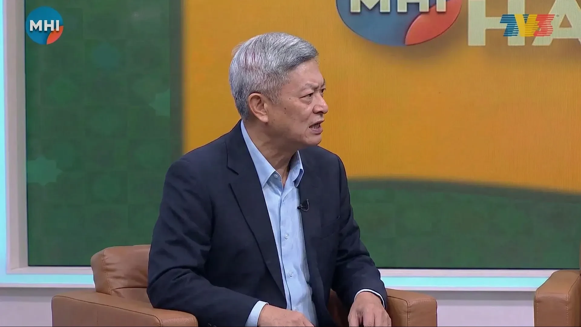A person speaking in a studio